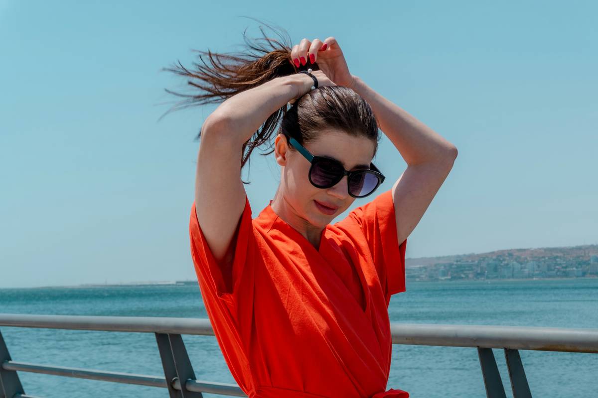 Professional stylist using a dual voltage flat iron in a European hotel bathroom