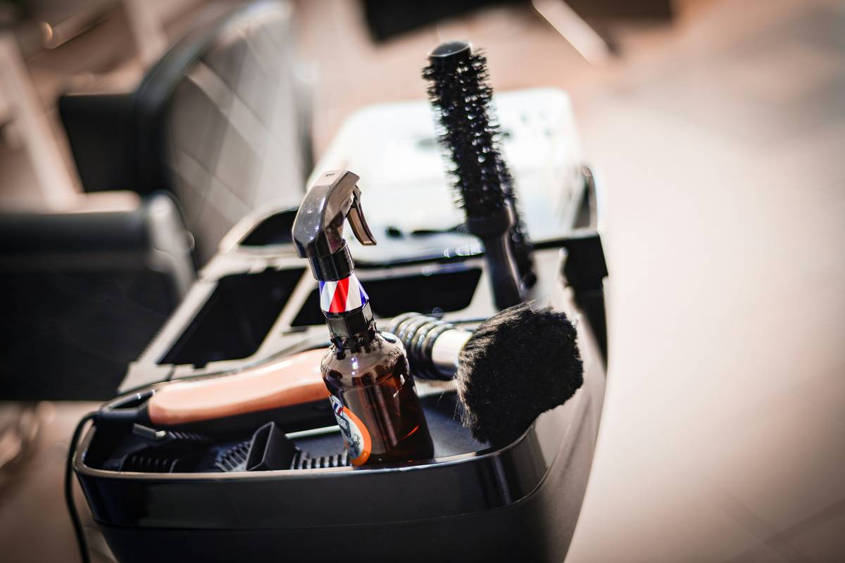 Infographic showing 5 essential hair styling accessories: thermal protection spray, ceramic sectioning clips, wide-tooth heat-safe comb, microfiber towel, and cool-shot hair dryer nozzle