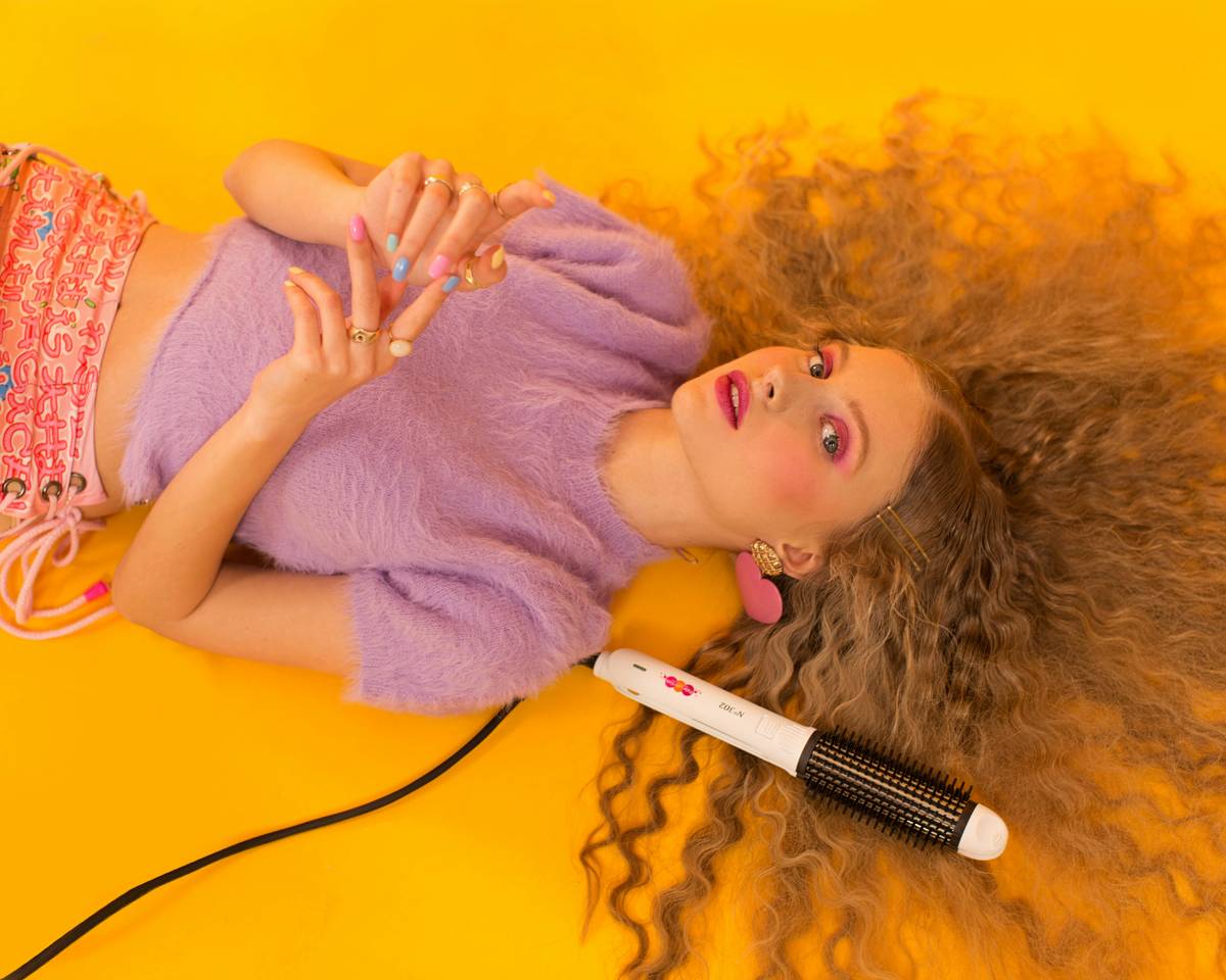 Close-up of hair curling irons showing digital temperature display and ergonomic handle design